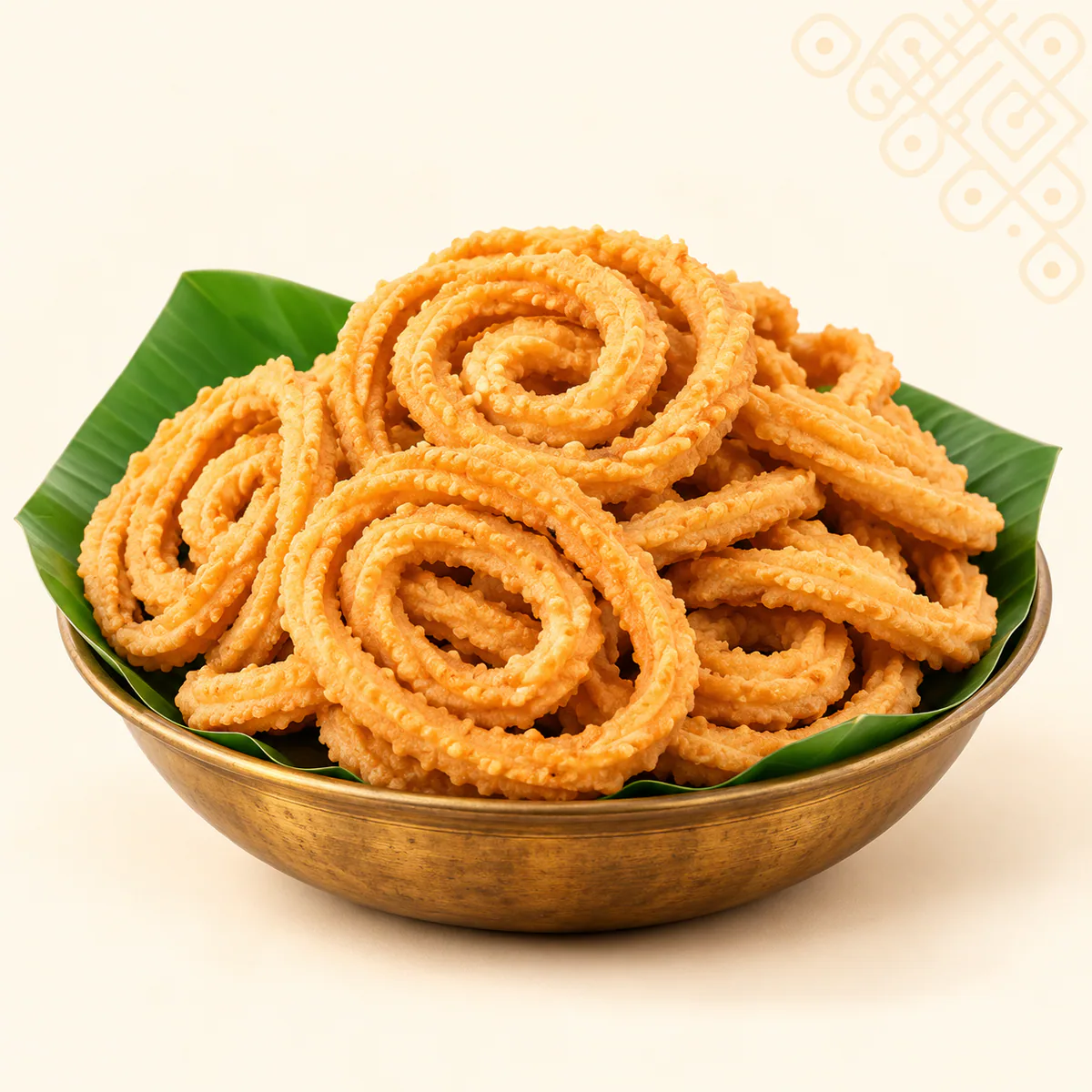 Kai Murukku served in a traditional brass bowl on banana leaf